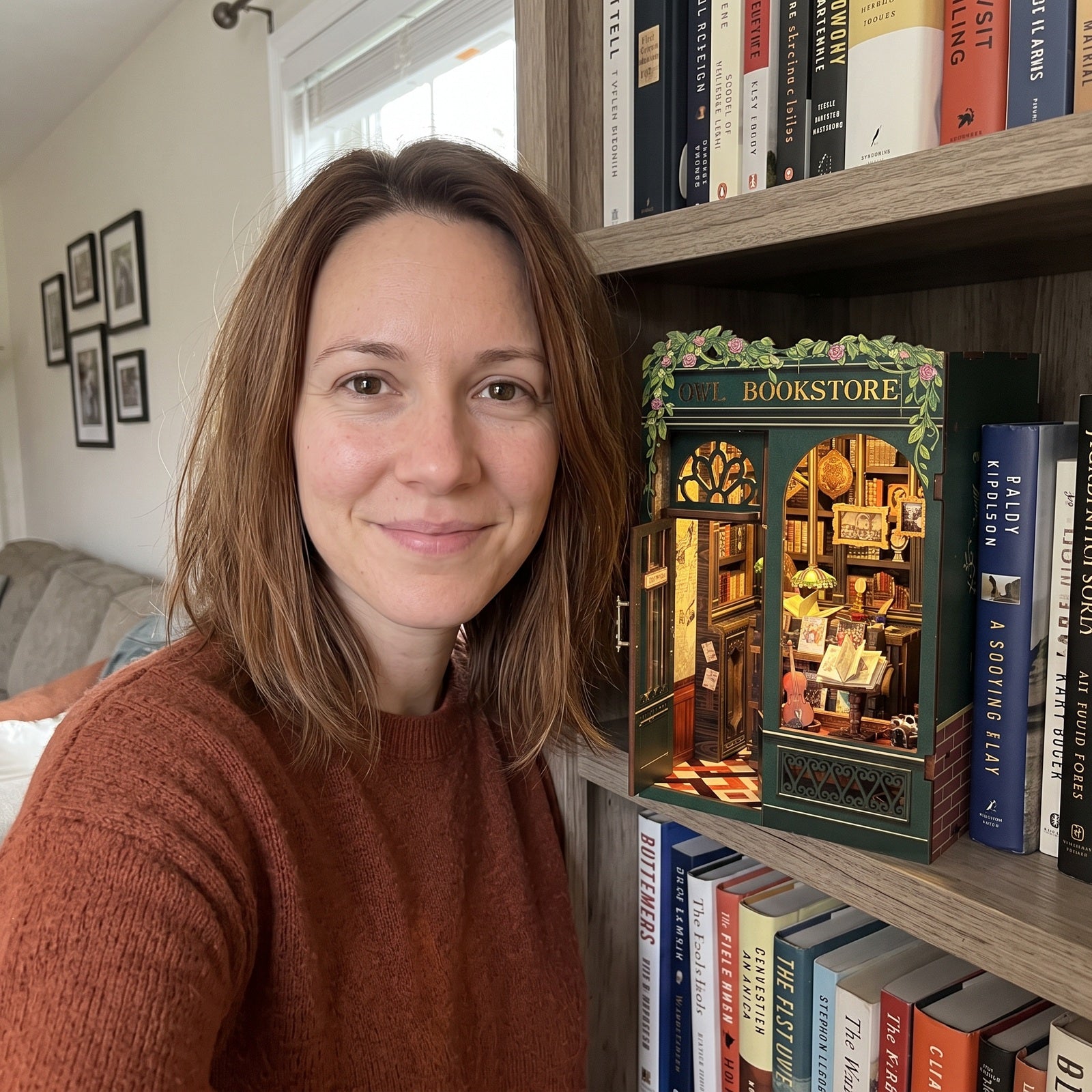 Front-camera portrait beside a lit Owl book nook at home