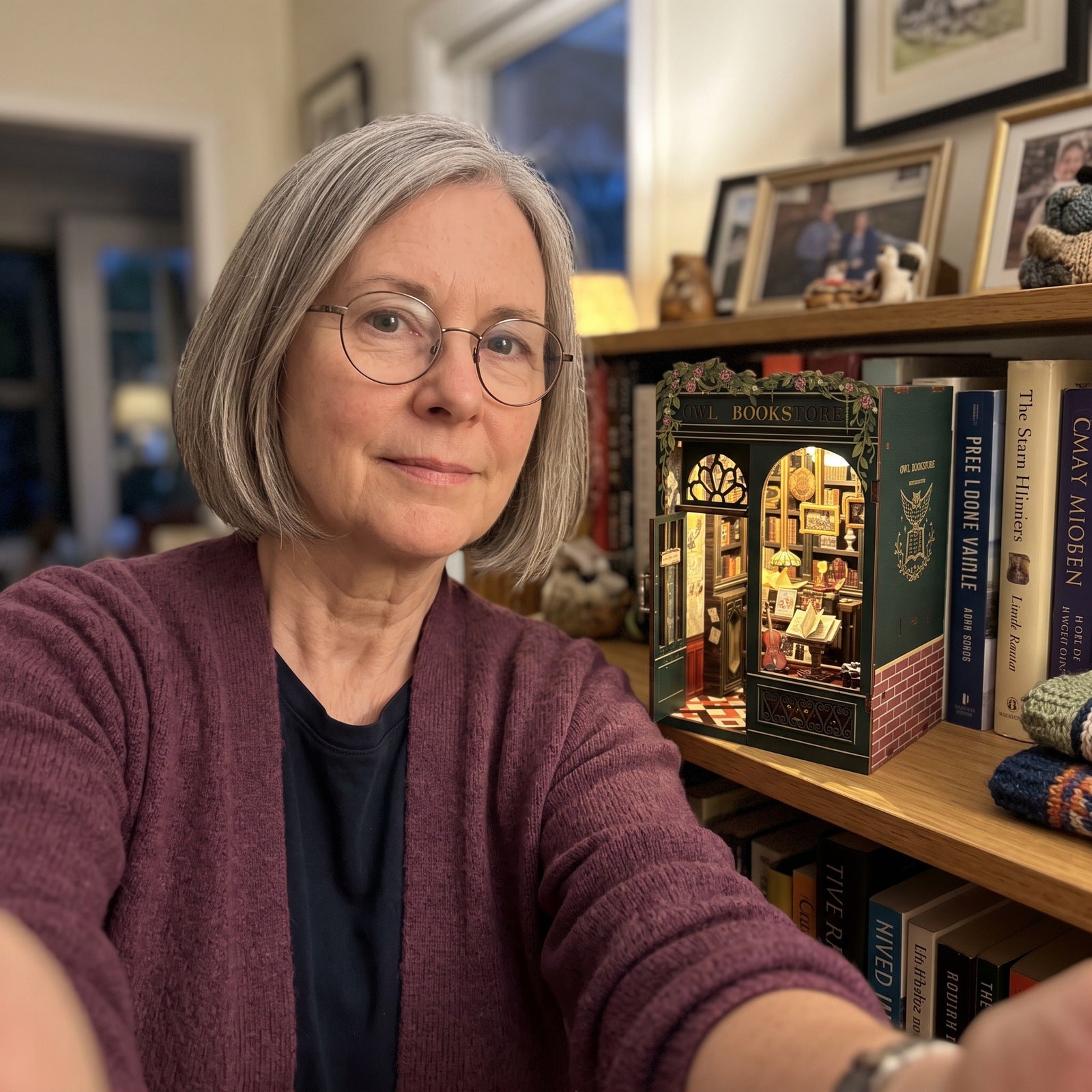 Mature woman taking a selfie with her Owl book nook in a study
