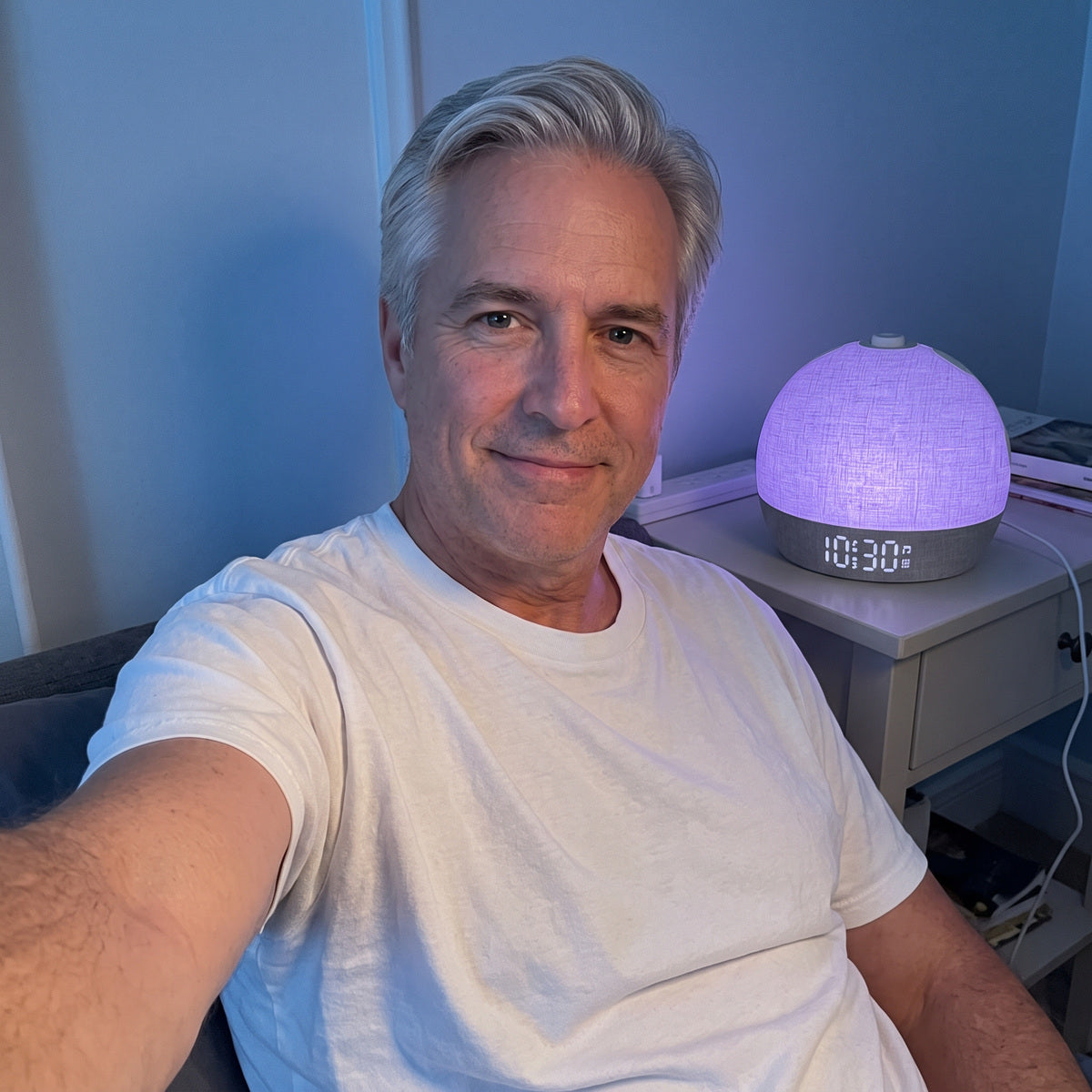 Man’s front-camera evening selfie beside purple Daybreak