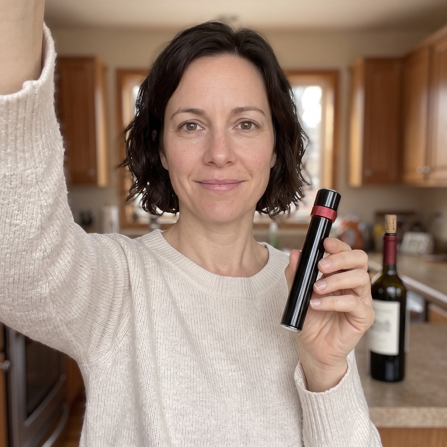 Woman holding a Red Openvale opener in her kitchen