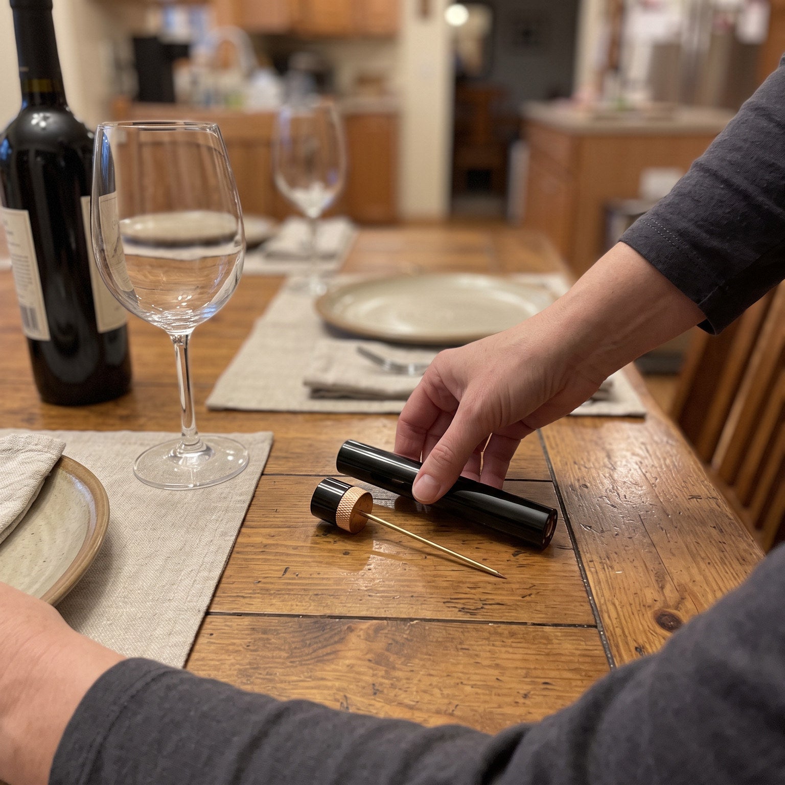 Rose Gold Openvale opener beside a laid dinner table